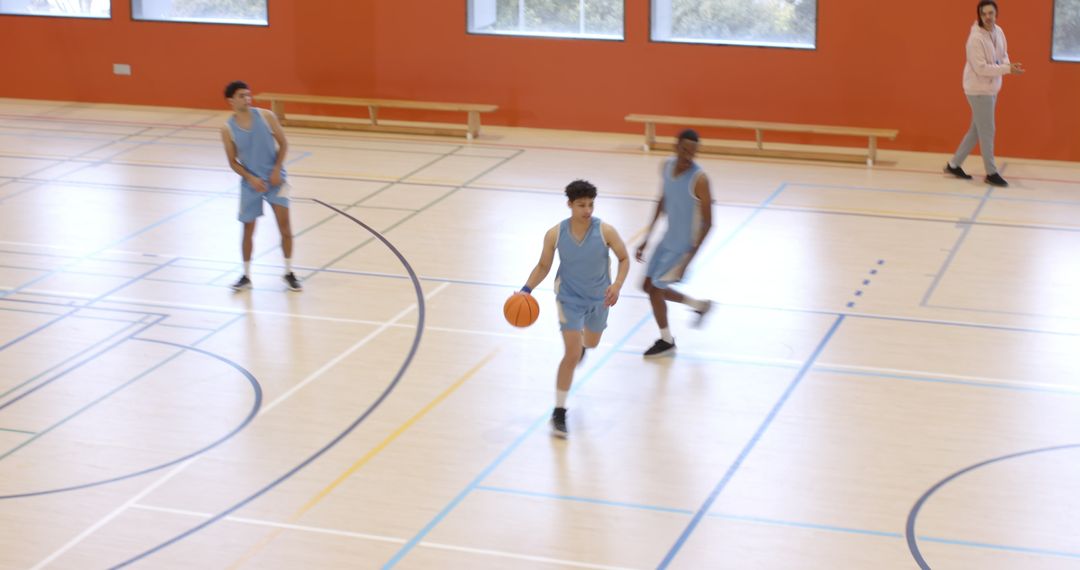 Youth Basketball Team Practicing in Indoor Gym