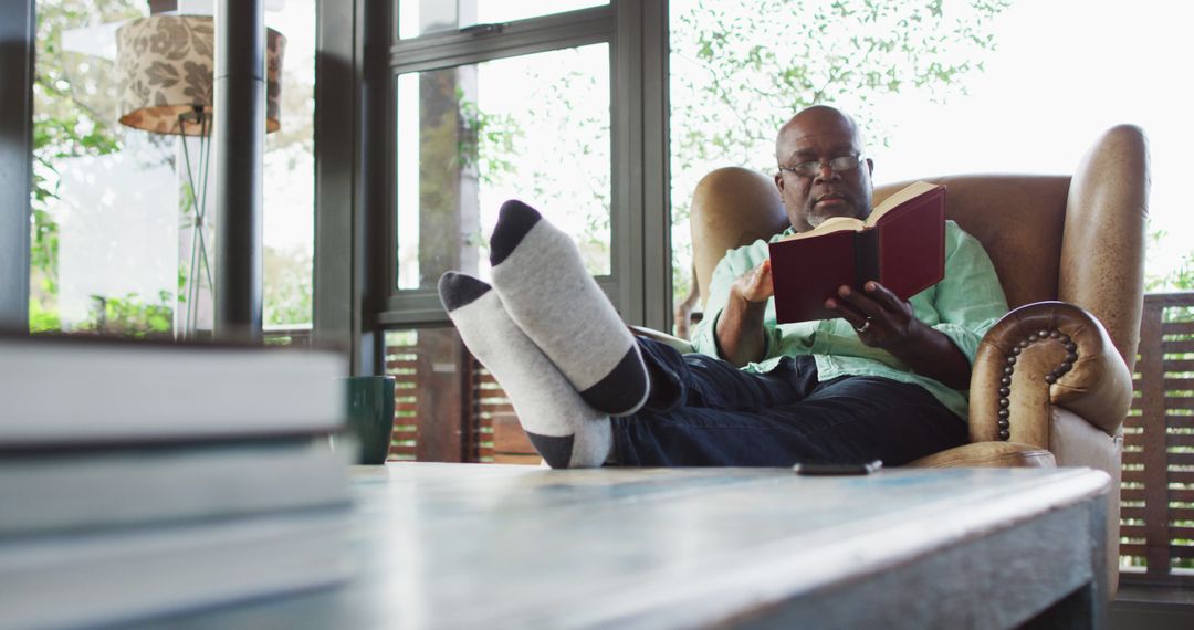 Senior Man Enjoying Reading in Cozy Home Environment