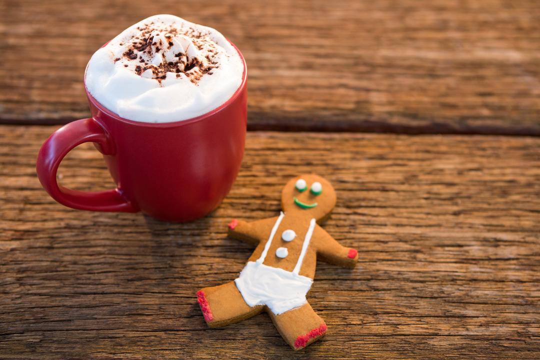 Festive Coffee with Gingerbread Man on Wooden Table - Free Images, Stock Photos and Pictures on Pikwizard.com