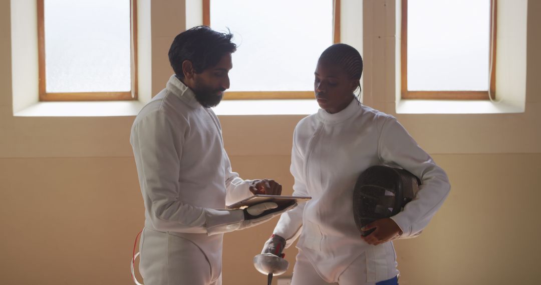 Fencing Coach Providing Guidance to Athlete During Training - Free Images, Stock Photos and Pictures on Pikwizard.com