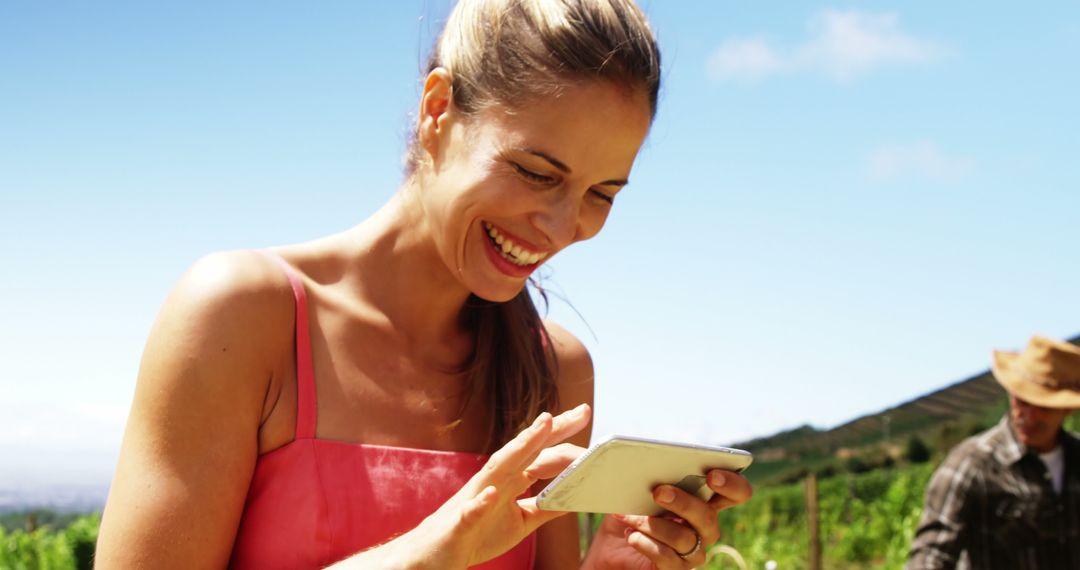 Happy Woman Using Tablet in a Vineyard on a Sunny Day - Free Images, Stock Photos and Pictures on Pikwizard.com