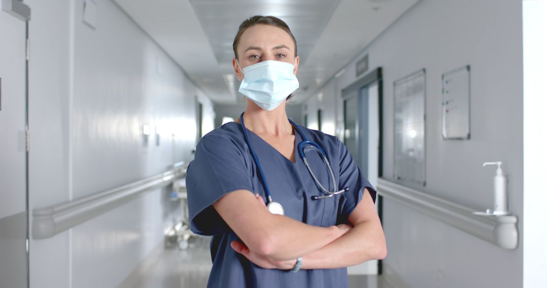 Confident Nurse Standing in Hospital Corridor Wearing Face Mask - Free Images, Stock Photos and Pictures on Pikwizard.com