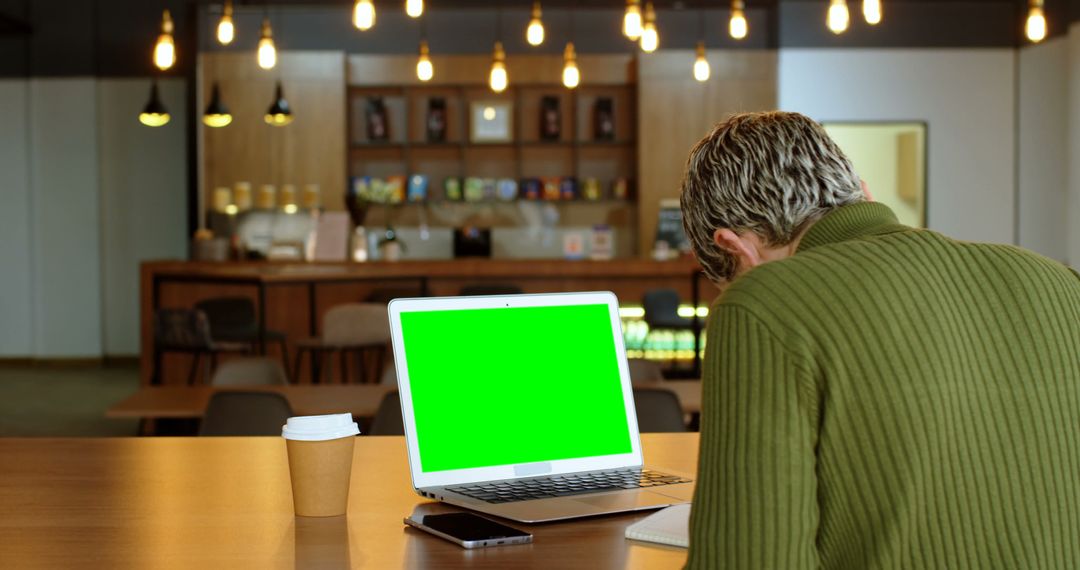 Man Working in Coffee Shop with Laptop, Green Screen Display - Free Images, Stock Photos and Pictures on Pikwizard.com