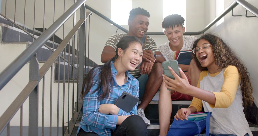 Diverse Teens Laughing on School Stairs Enjoying Break