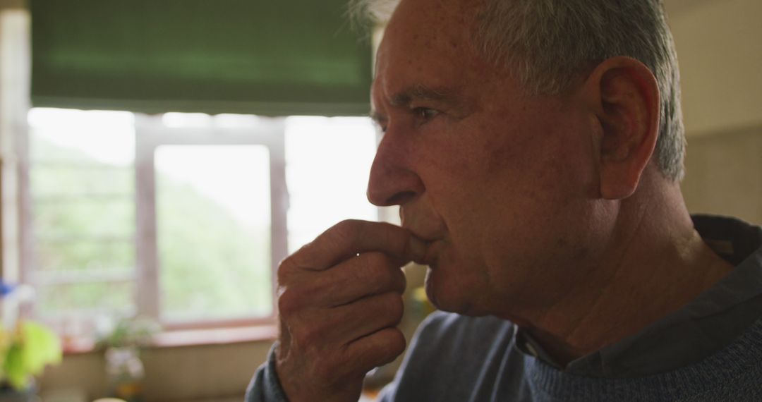 Elderly Man Reflecting at Home by Window - Free Images, Stock Photos and Pictures on Pikwizard.com