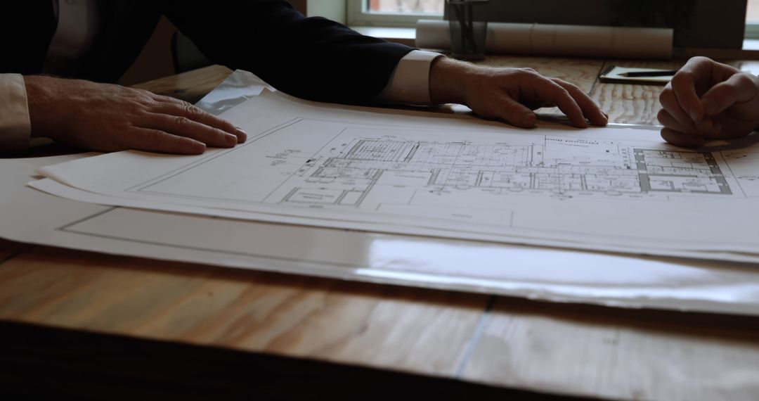 Architects Discussing Blueprint Plans in Office Meeting