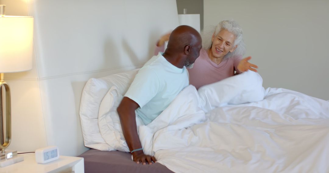 Senior Couple Enjoying Morning Conversation in Cozy Bedroom