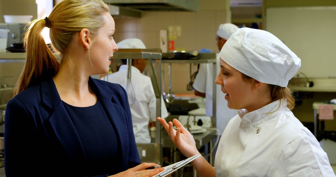 Professional Kitchen Staff Discussing Meal Preparation - Free Images, Stock Photos and Pictures on Pikwizard.com