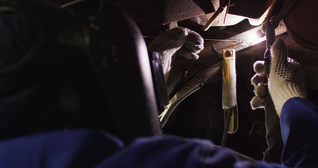 Mechanic Welding Under a Vehicle Wearing Protective Gear - Free Images, Stock Photos and Pictures on Pikwizard.com