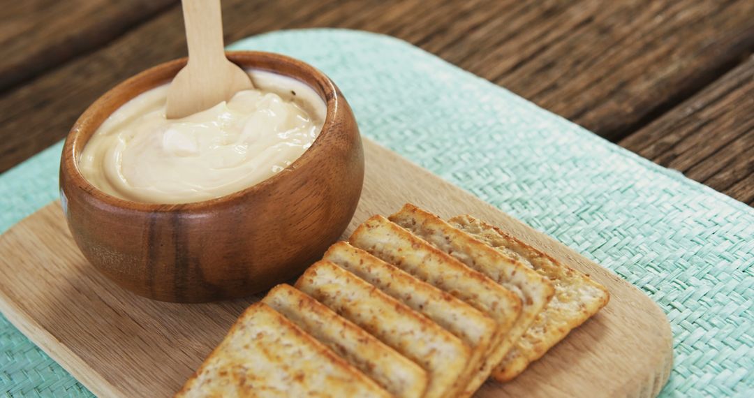 Creamy Dip with Seasoned Crackers on Bamboo Board - Free Images, Stock Photos and Pictures on Pikwizard.com