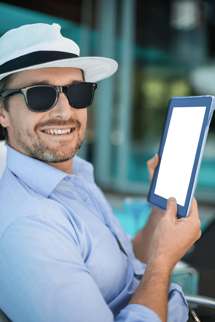 Smiling Man in Hat Holding Blank Transparent Tablet Outdoors