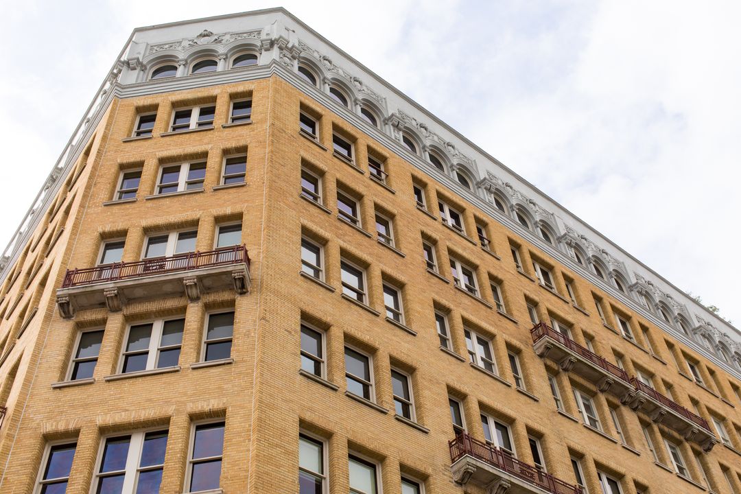 Historic Building Facade with Symmetrical Windows Against Sky