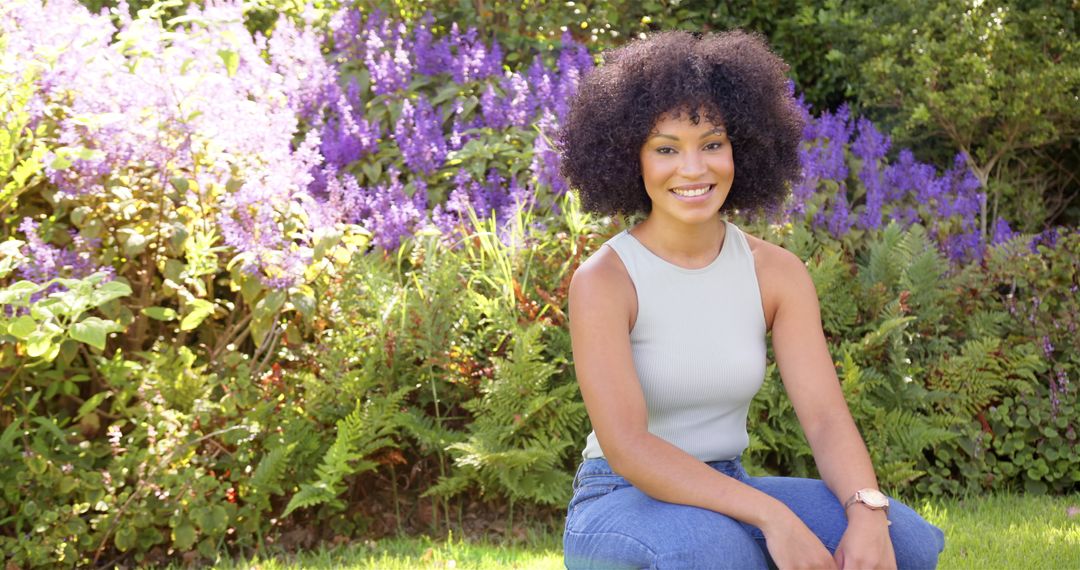 Smiling Woman Enjoying Sunny Day in Flower Garden