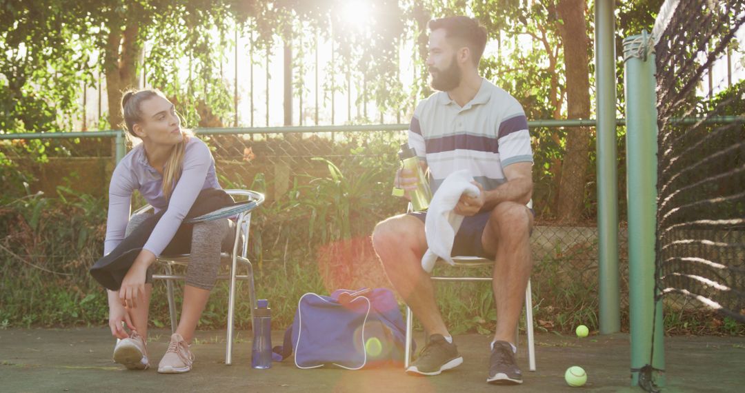 Image of happy caucasian couple on having break the court - Free Images, Stock Photos and Pictures on Pikwizard.com