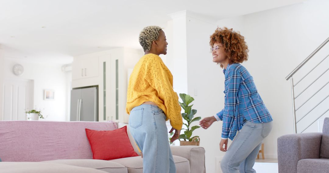 Joyful Lesbian Couple Dancing Together in Living Space - Free Images, Stock Photos and Pictures on Pikwizard.com