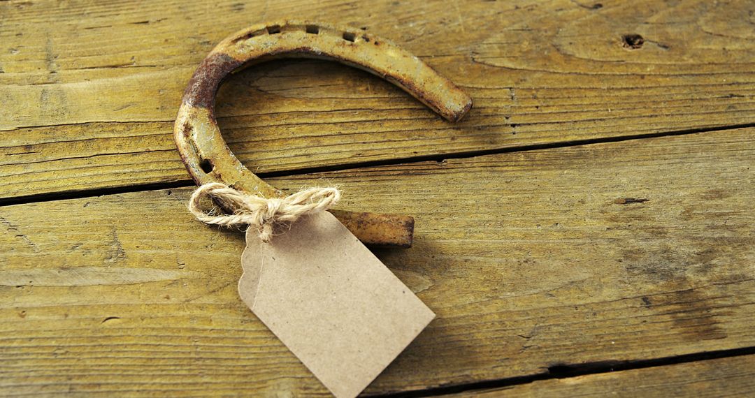 Rustic Horseshoe with Blank Tag on Wooden Surface for Luck and Charm - Free Images, Stock Photos and Pictures on Pikwizard.com