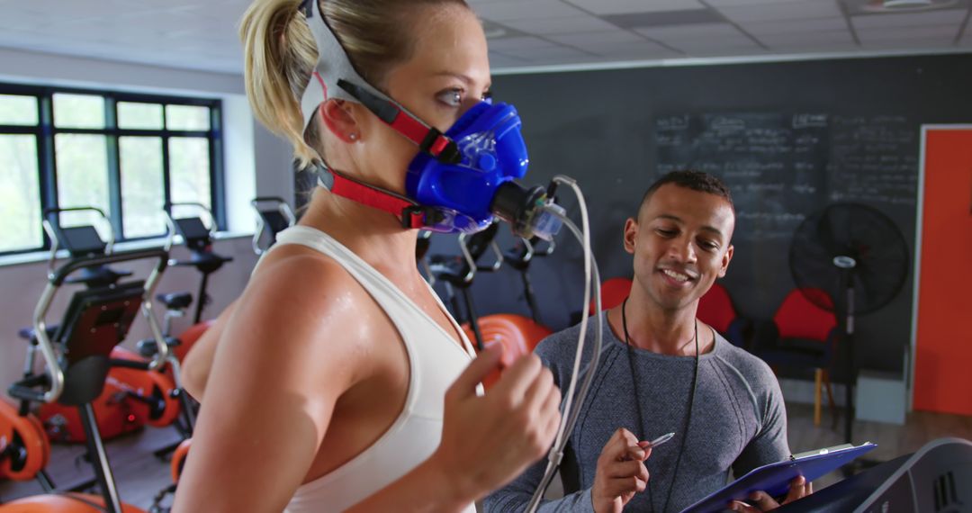 Fitness Trainer Conducting VO2 Max Test with Athlete on Treadmill - Free Images, Stock Photos and Pictures on Pikwizard.com