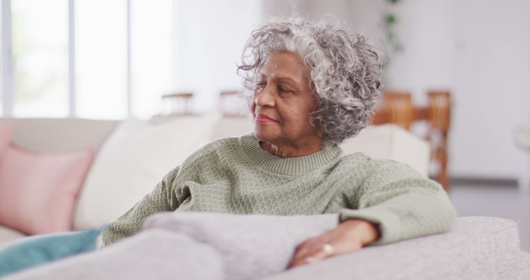 Serene Elderly Woman Relaxing on Couch in Cozy Living Room - Free Images, Stock Photos and Pictures on Pikwizard.com