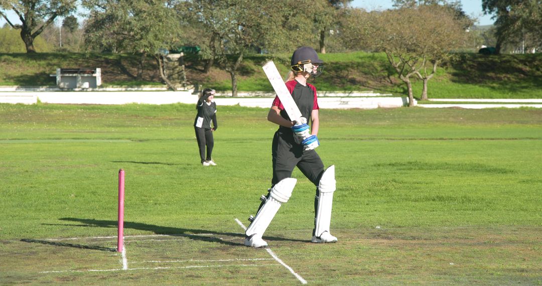 Female Cricketers Playing Intense Match on Sunlit Field