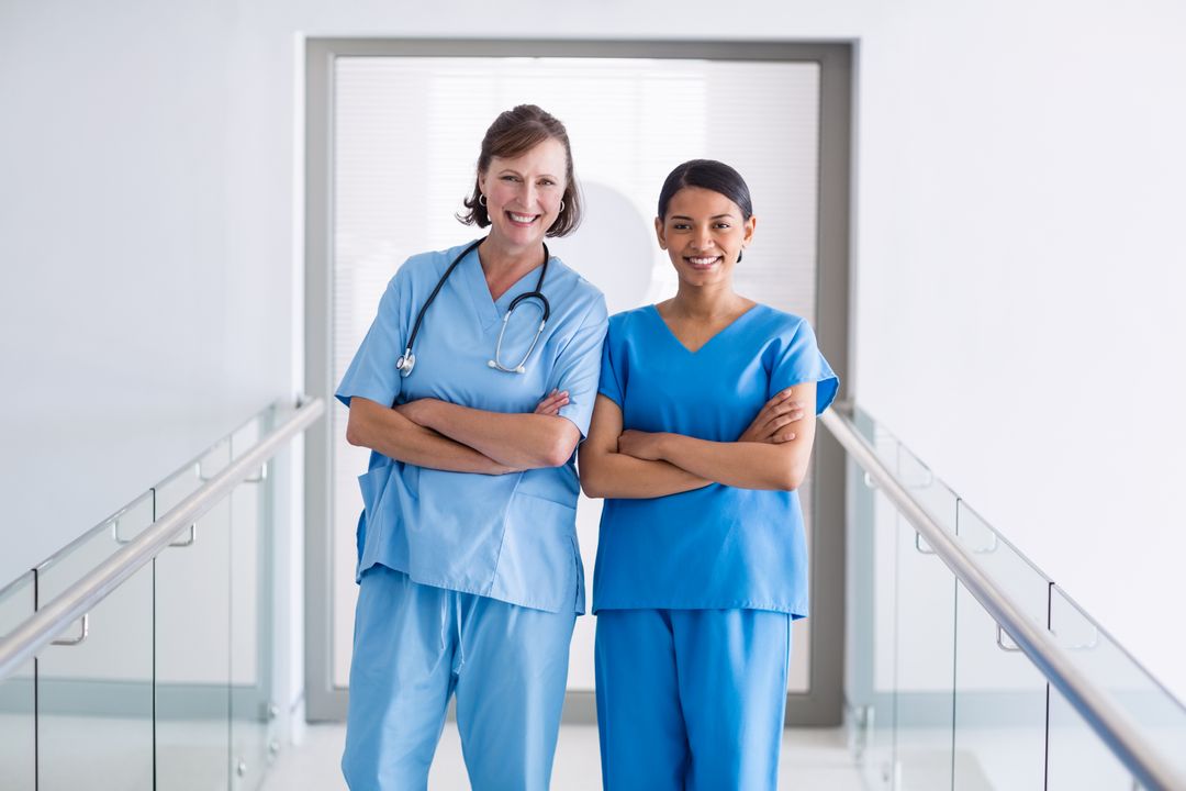 Portrait of smiling nurse and doctor standing with arms crossed - Free Images, Stock Photos and Pictures on Pikwizard.com