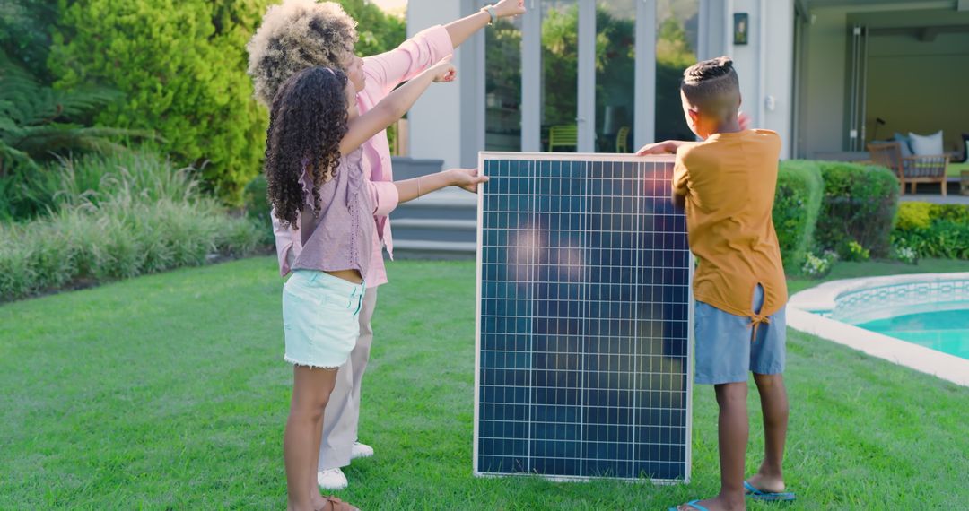 Family Exploring Renewable Energy with Solar Panel in Backyard