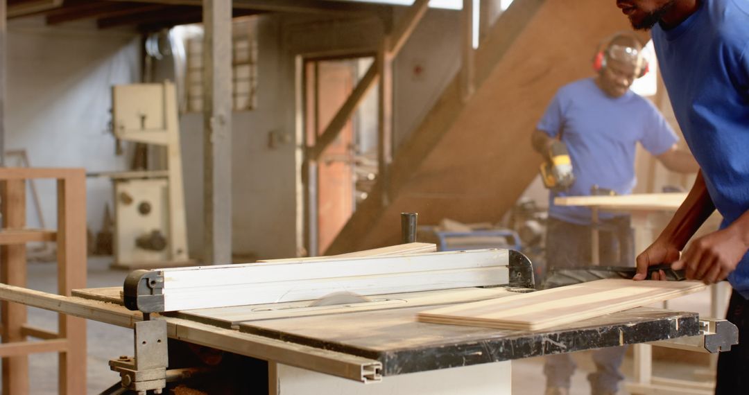 Men Operating Table Saw in Carpentry Workshop Crafting Wood