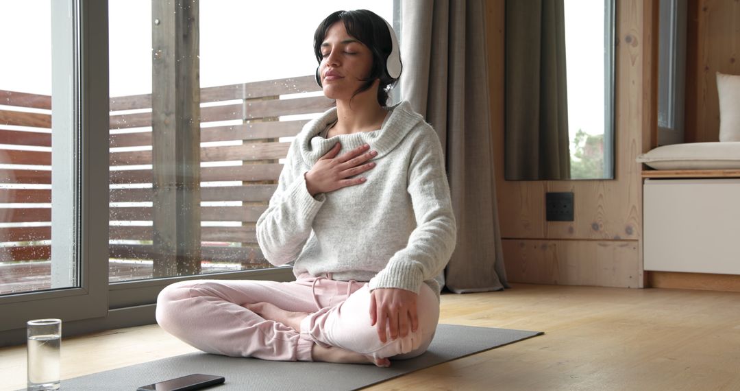 Woman Practicing Mindfulness Meditation with Headphones at Home