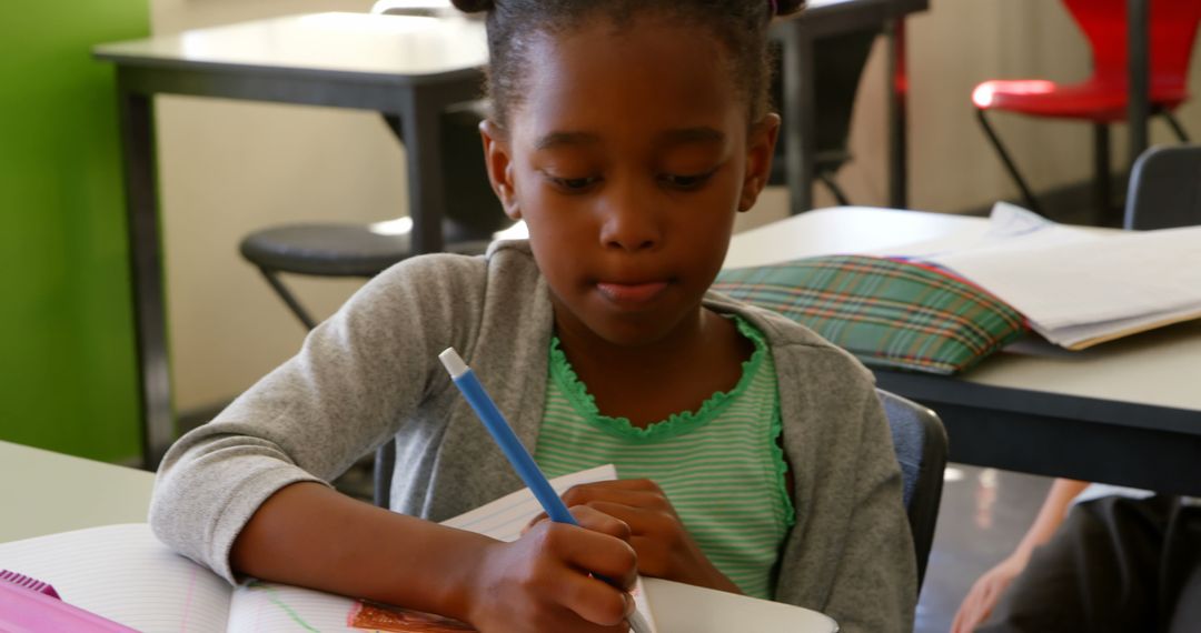Focused Schoolgirl Drawing in Classroom Setting