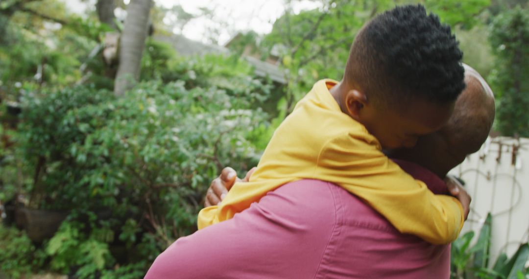 African American father hugging young son outdoors - Free Images, Stock Photos and Pictures on Pikwizard.com