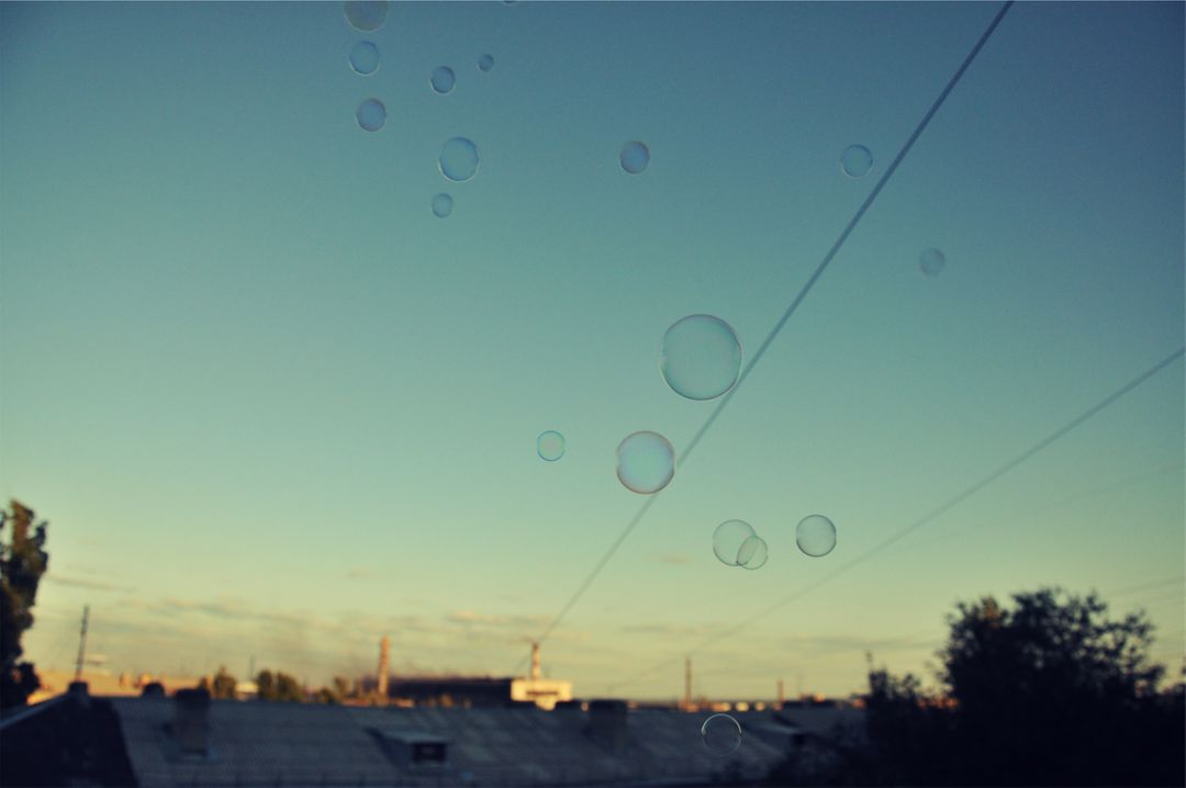 Soap Bubbles Floating in Clear Blue Sky at Sunset - Free Images, Stock Photos and Pictures on Pikwizard.com