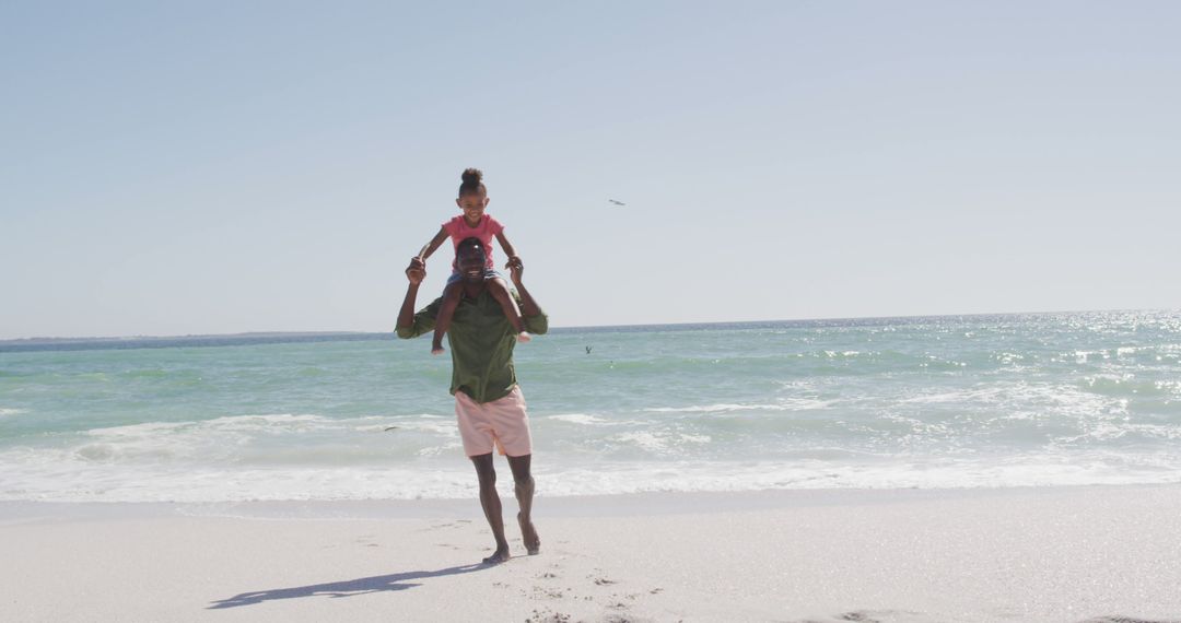 Father Holding Daughter on Shoulders at the Beach - Free Images, Stock Photos and Pictures on Pikwizard.com