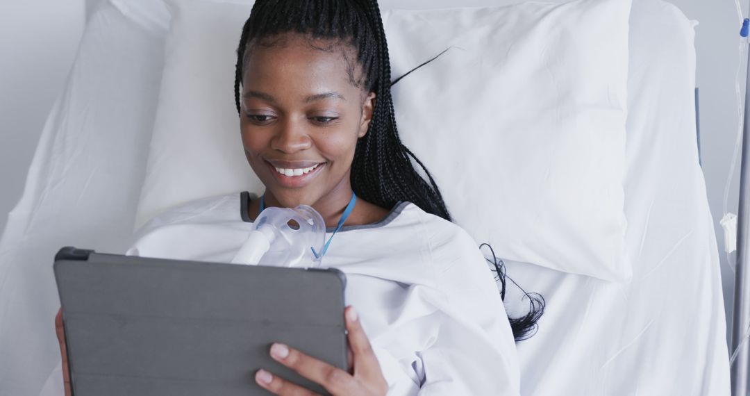 Smiling Patient Using Tablet in Hospital Bed - Free Images, Stock Photos and Pictures on Pikwizard.com