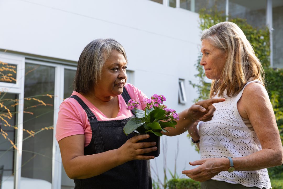 Diverse Senior Friends Discussing Flowers on Patio