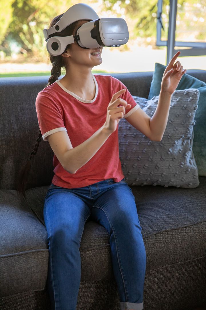 Smiling Woman Enjoying Virtual Reality Experience at Home