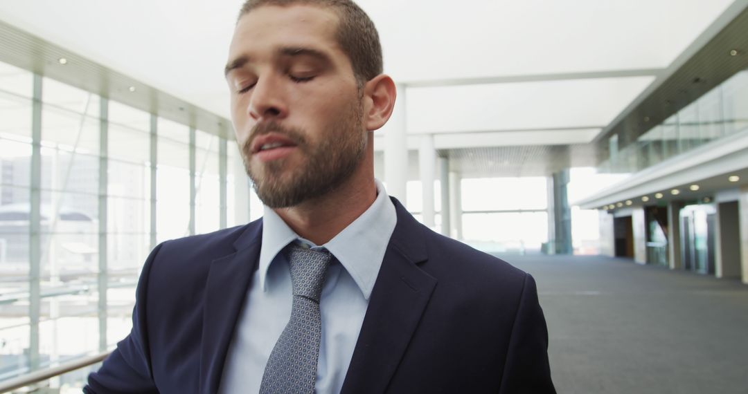 Businessman in Suit Taking a Pause in Modern Office Hallway - Free Images, Stock Photos and Pictures on Pikwizard.com