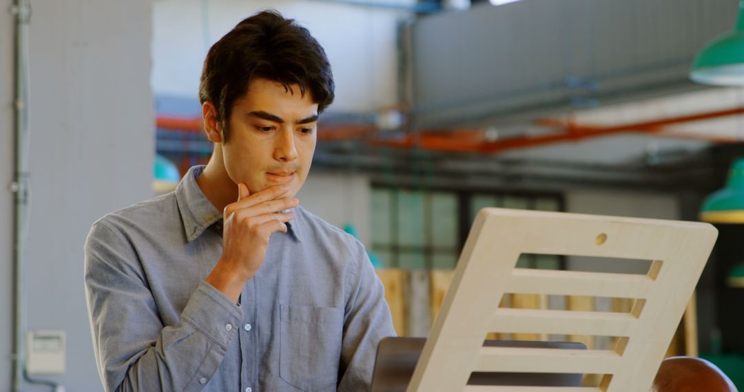 Thoughtful Man Pondering Work at Office Desk in Modern Workspace - Free Images, Stock Photos and Pictures on Pikwizard.com