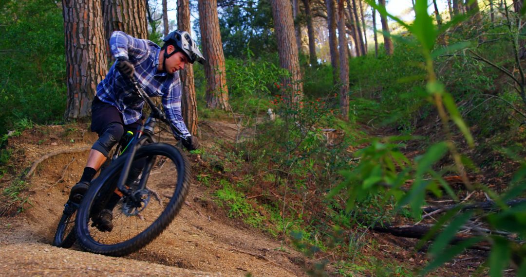 Man Riding Mountain Bike on Wooded Trail Intense Maneuver - Free Images, Stock Photos and Pictures on Pikwizard.com