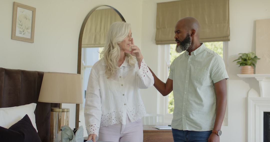 Couple Organizing Wardrobe in Bright Bedroom Interior