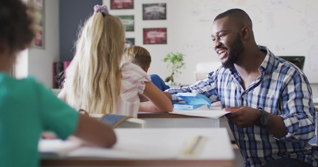 Smiling African-American Teacher Assisting Students in Classroom Setting - Free Images, Stock Photos and Pictures on Pikwizard.com