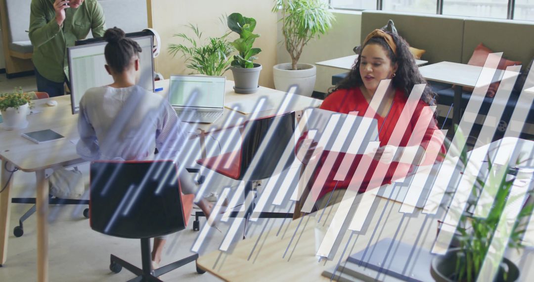 Busy Open-Plan Office with Overlapping Data Graphics