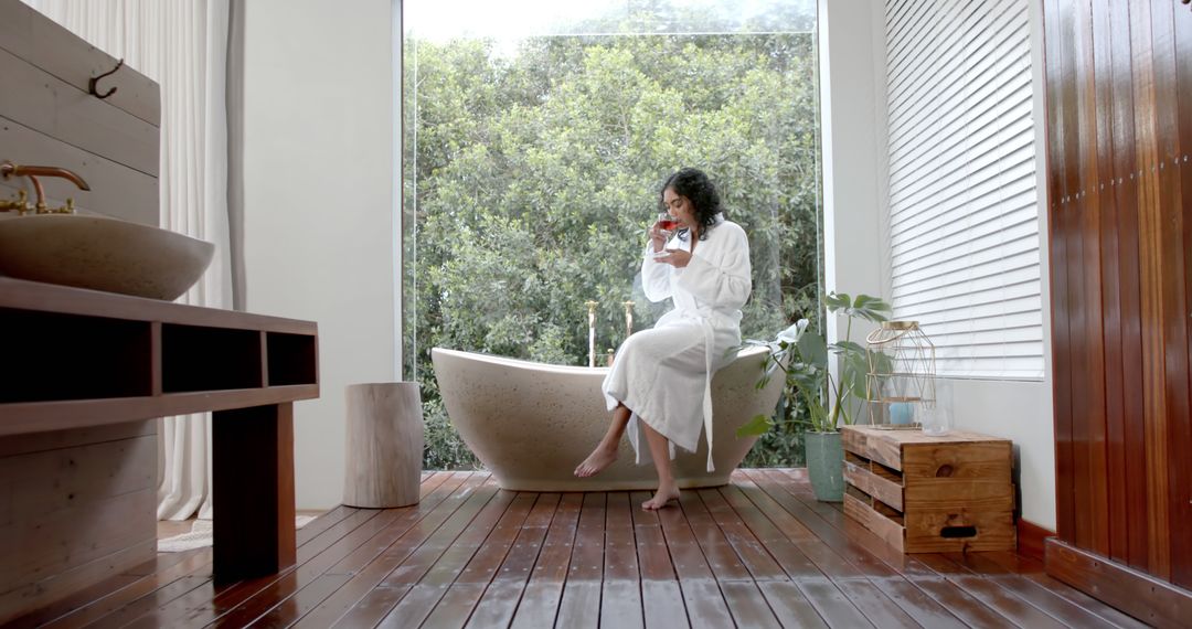 Peaceful Morning: Woman in Bathrobe Drinking Coffee in Luxurious Bathroom - Free Images, Stock Photos and Pictures on Pikwizard.com