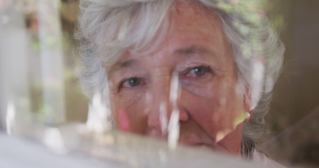 Elderly Woman Contemplating Through a Window - Free Images, Stock Photos and Pictures on Pikwizard.com