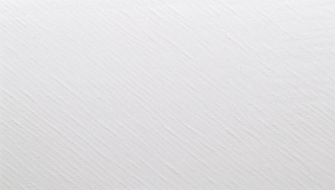 Macro close-up showing off-white textured surface with diagonal ridges and grooves