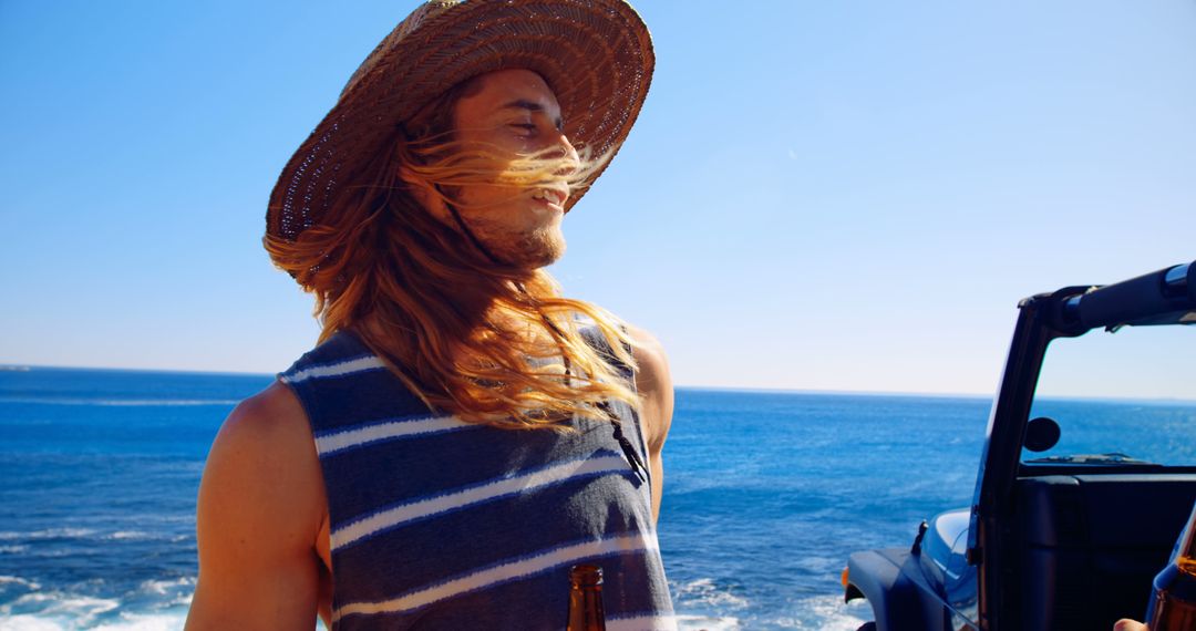 Man with Long Hair Enjoying Coastal Views During Summer Trip - Free Images, Stock Photos and Pictures on Pikwizard.com