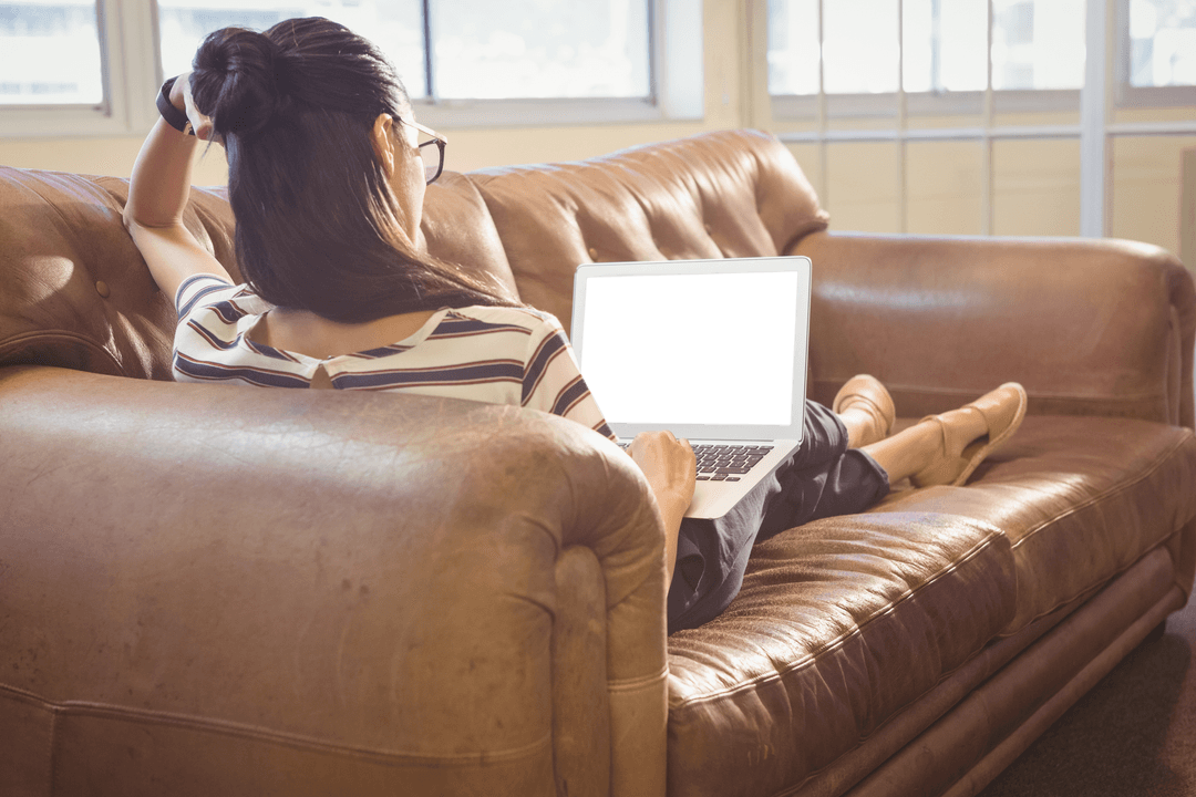 Businesswoman Relaxing on Sofa with Transparent Laptop