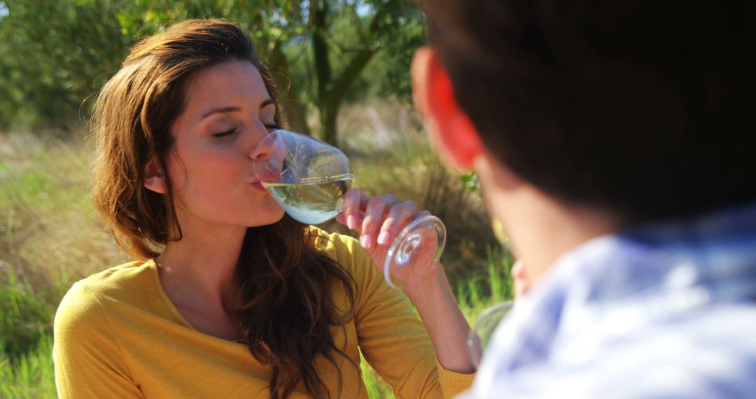 A woman enjoys wine on a casual outdoor date, evoking a sense of intimacy and relaxation. - Free Images, Stock Photos and Pictures on Pikwizard.com