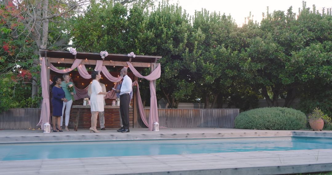 Diverse Group Celebrating Wedding by Poolside in Summer Garden