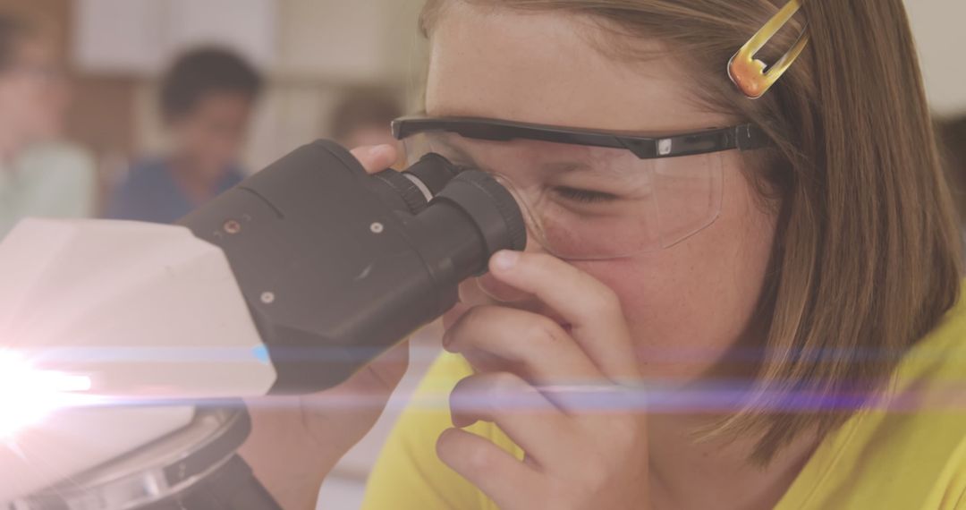 Caucasian Schoolgirl Enthralled by Scientific Exploration Using Microscope
