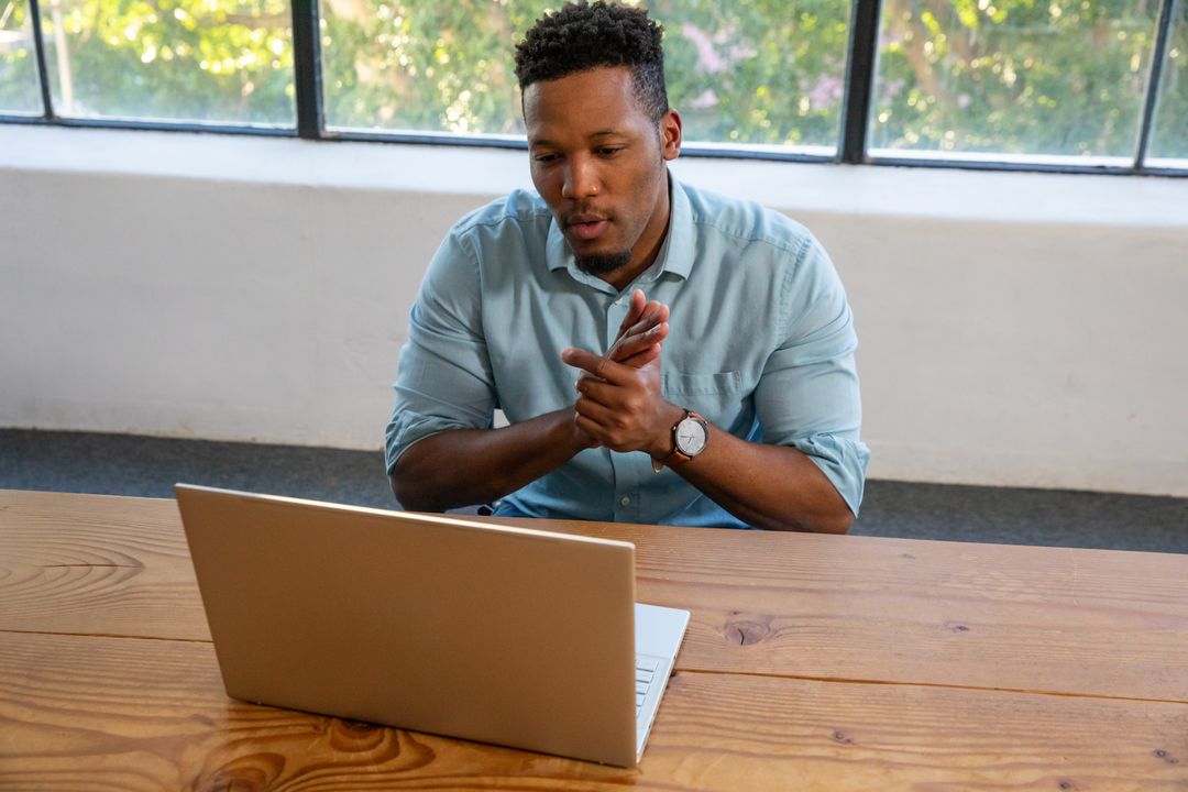 Professional Man Engaged in Video Call on Laptop