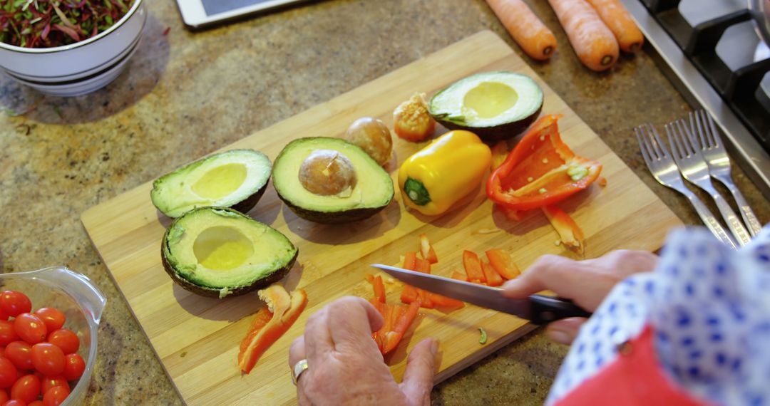 Person Preparing Healthy Salad with Fresh Vegetables in Kitchen - Free Images, Stock Photos and Pictures on Pikwizard.com